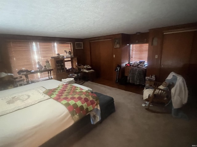 carpeted bedroom featuring a textured ceiling