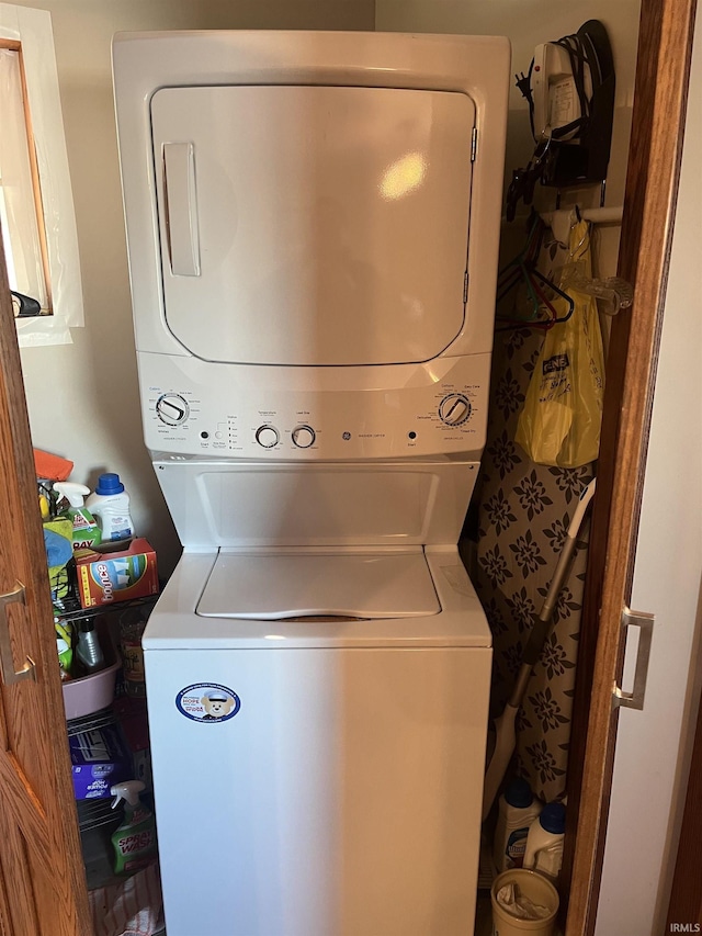 laundry area with stacked washer and dryer