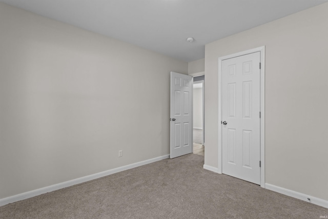 unfurnished bedroom featuring light colored carpet