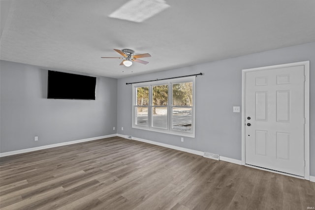 interior space featuring wood-type flooring and ceiling fan