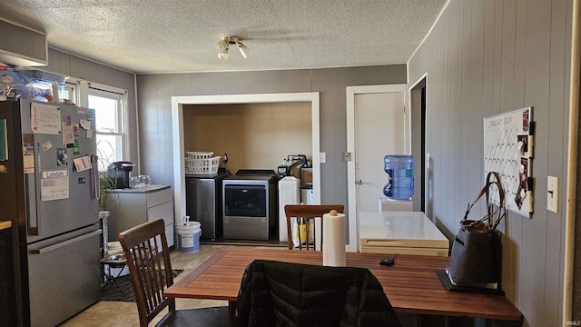 dining area featuring washing machine and clothes dryer and wooden walls