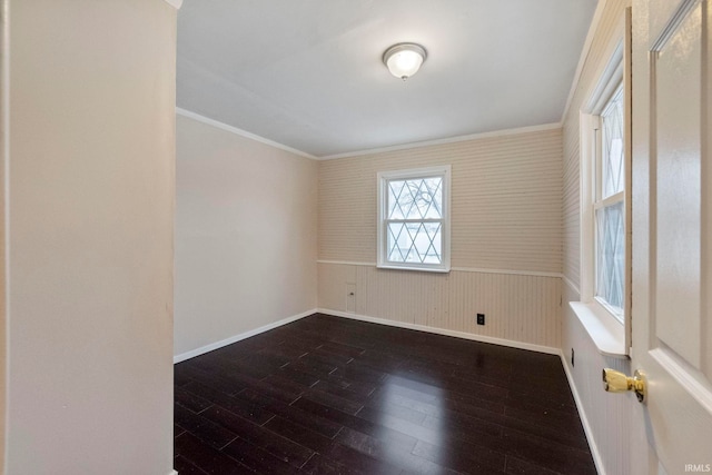 unfurnished room featuring ornamental molding and dark hardwood / wood-style floors