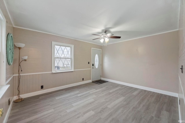 unfurnished room with ceiling fan, ornamental molding, and light hardwood / wood-style flooring