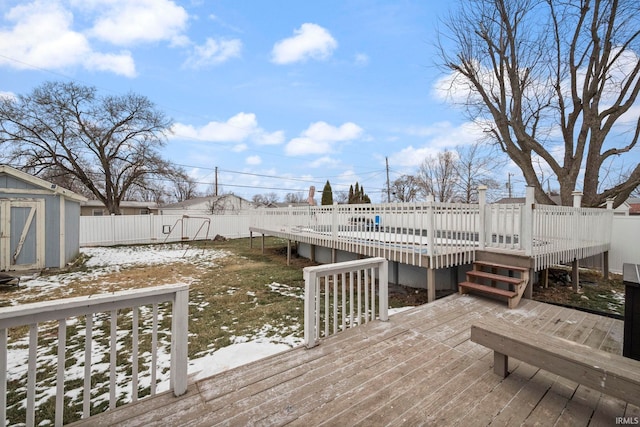 snow covered deck with a storage unit