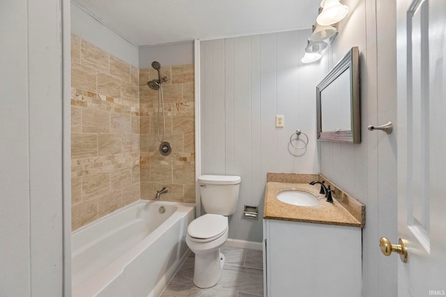 full bathroom with tiled shower / bath, vanity, and toilet