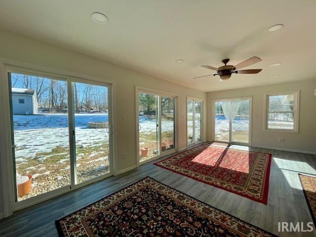 sunroom / solarium featuring ceiling fan