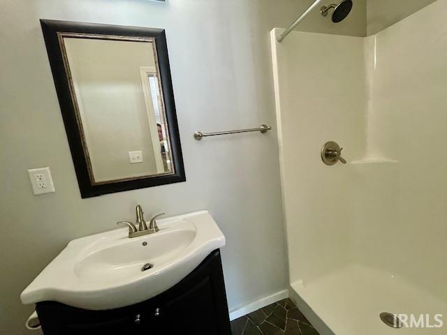 bathroom featuring vanity and walk in shower