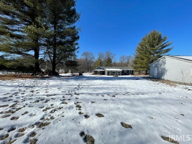 view of yard layered in snow