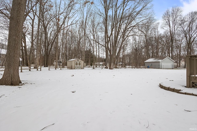 yard covered in snow featuring a shed