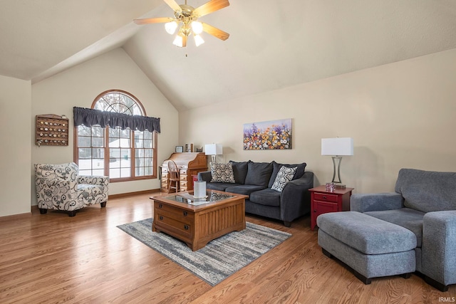 living room with ceiling fan, lofted ceiling, and light hardwood / wood-style flooring