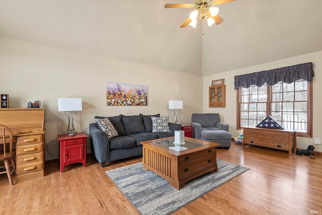 living room with vaulted ceiling, ceiling fan, and light hardwood / wood-style flooring