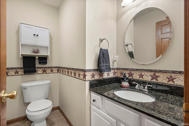 bathroom with vanity, tile patterned floors, and toilet