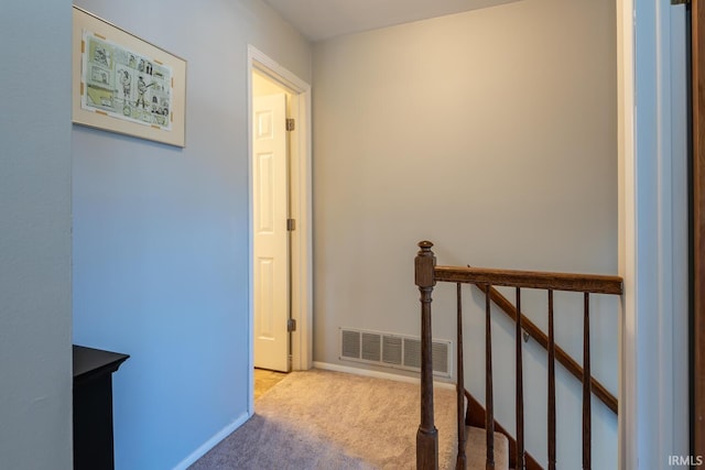 hallway featuring light carpet