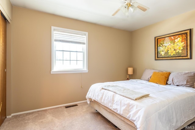 bedroom with ceiling fan, a closet, and carpet