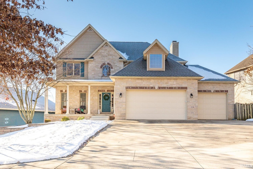 view of front of property featuring a porch and a garage