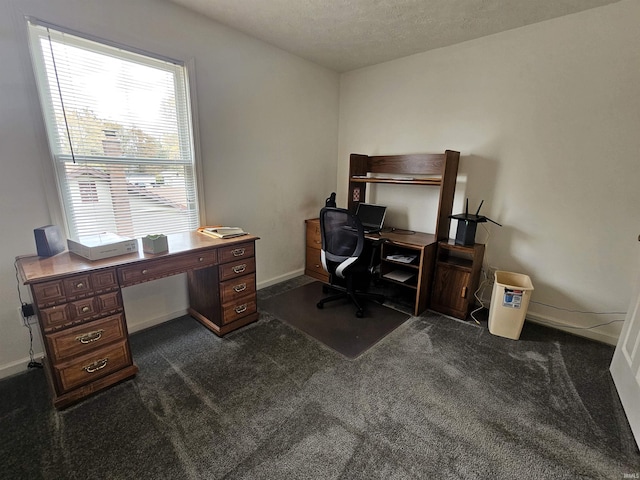 home office with dark carpet and a textured ceiling