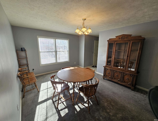 dining area with dark colored carpet, a textured ceiling, and a notable chandelier