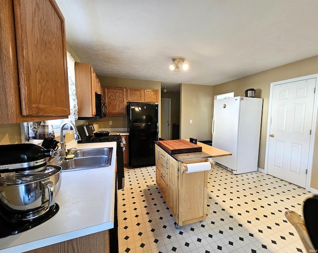 kitchen with a center island, sink, and black appliances