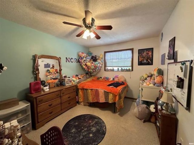 bedroom featuring carpet flooring, a textured ceiling, and ceiling fan