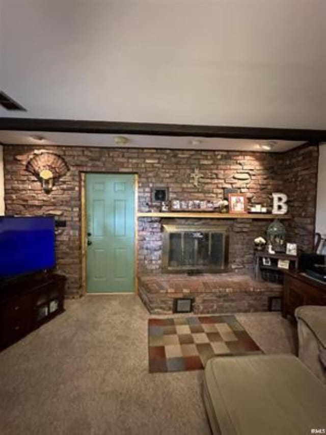 living room featuring a fireplace and carpet