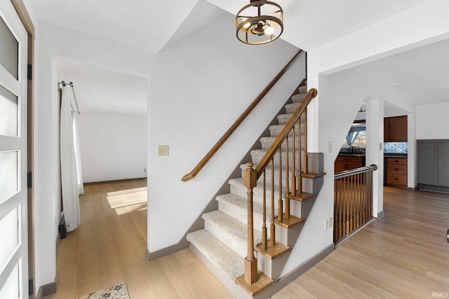 stairs with wood-type flooring