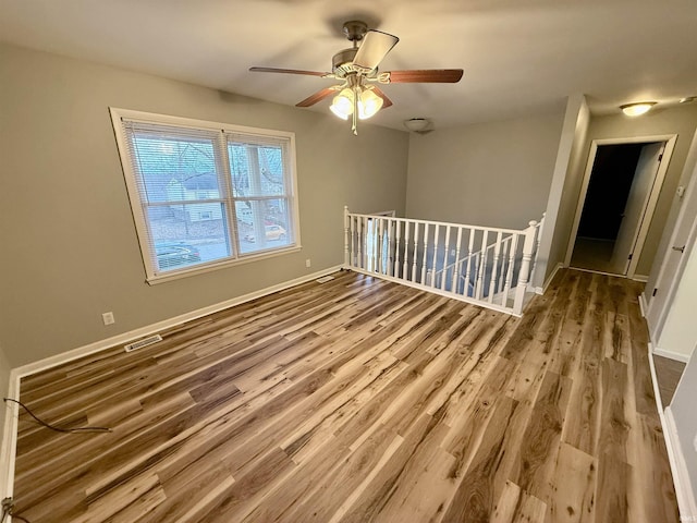 unfurnished room featuring wood-type flooring and ceiling fan