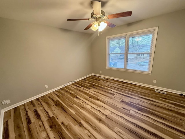 spare room featuring ceiling fan and hardwood / wood-style floors