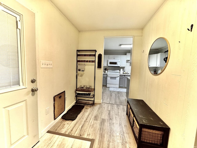 corridor with light hardwood / wood-style floors