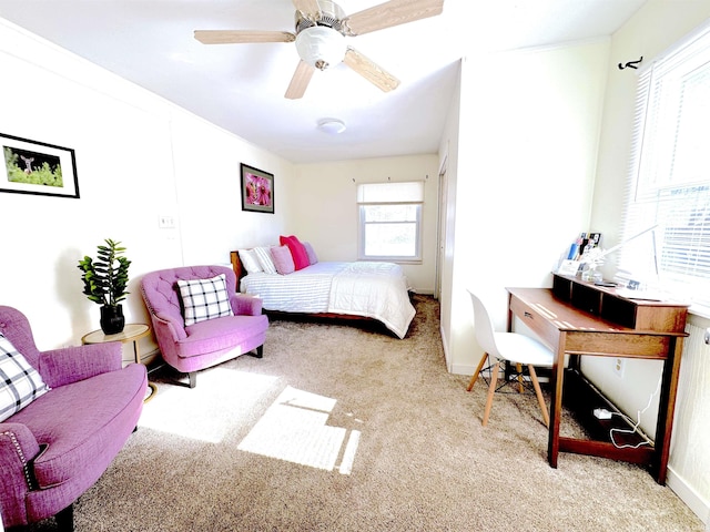 bedroom with ceiling fan and light carpet