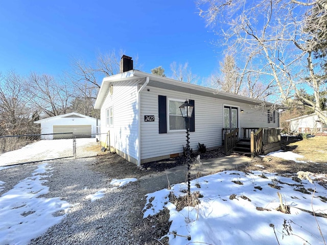 view of front of property featuring a garage and an outdoor structure