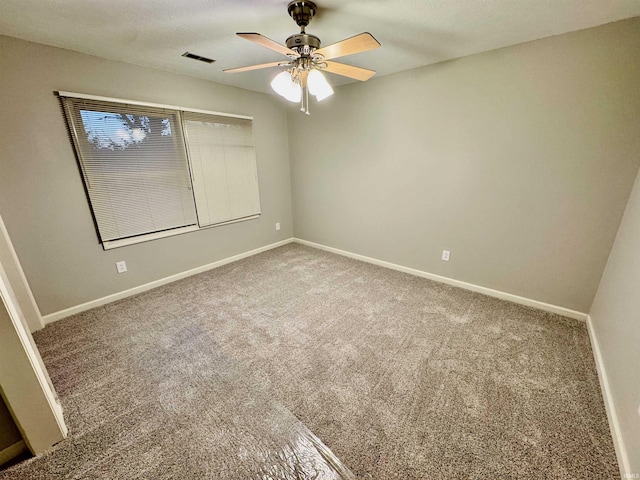 carpeted spare room featuring ceiling fan