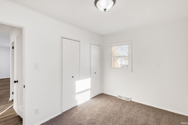 unfurnished bedroom featuring dark colored carpet