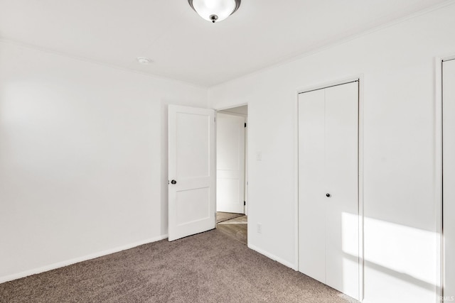 unfurnished bedroom featuring light colored carpet and a closet