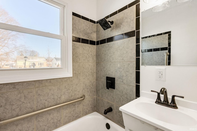 bathroom featuring vanity and tiled shower / bath combo