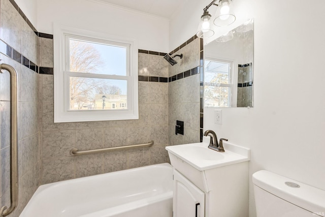 full bathroom featuring tiled shower / bath combo, vanity, and toilet