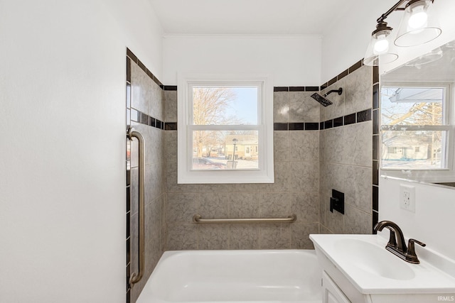 bathroom with tiled shower / bath and vanity