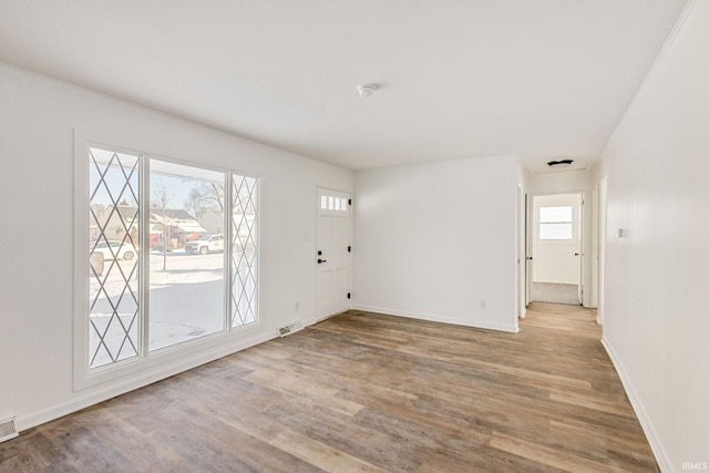 empty room with light hardwood / wood-style floors