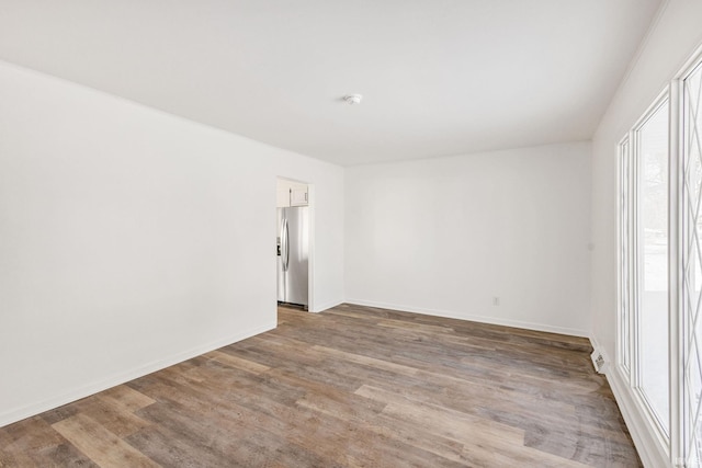 spare room with hardwood / wood-style flooring