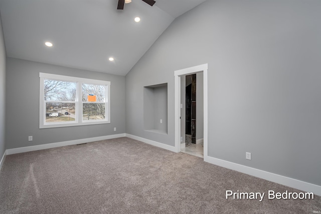 unfurnished bedroom with ceiling fan, high vaulted ceiling, a spacious closet, and carpet floors