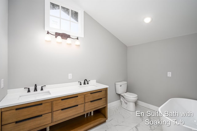 bathroom featuring vanity, a tub, lofted ceiling, and toilet