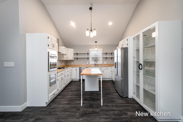 kitchen with white cabinetry, sink, stainless steel appliances, and a center island