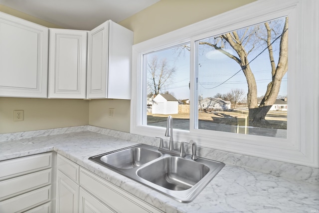 kitchen with white cabinetry, a healthy amount of sunlight, and sink