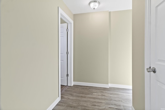 corridor with light hardwood / wood-style flooring