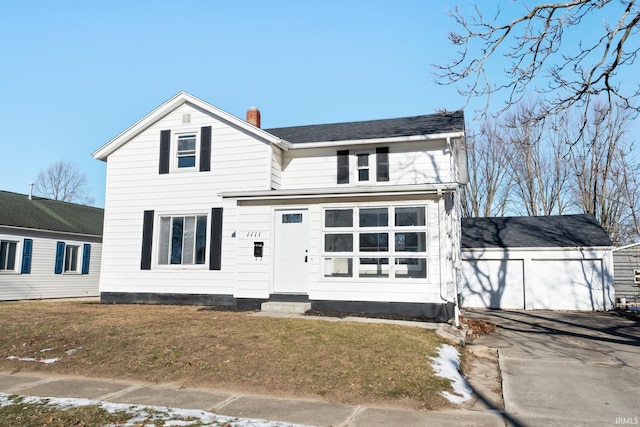 view of front property featuring a garage and a front lawn