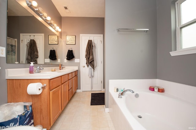 bathroom with a relaxing tiled tub and vanity