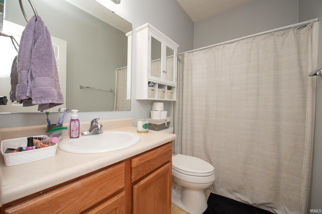 bathroom featuring vanity, toilet, and a textured ceiling