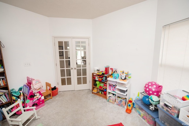 game room with french doors and light colored carpet