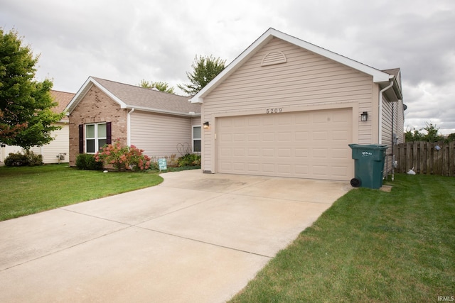 ranch-style home featuring a garage and a front lawn