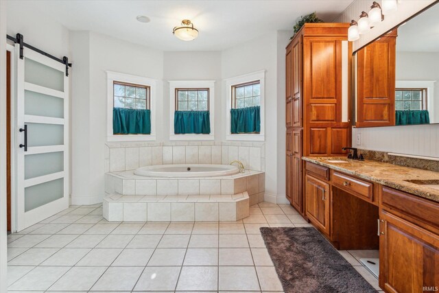 bathroom with vanity, tile patterned floors, and tiled bath