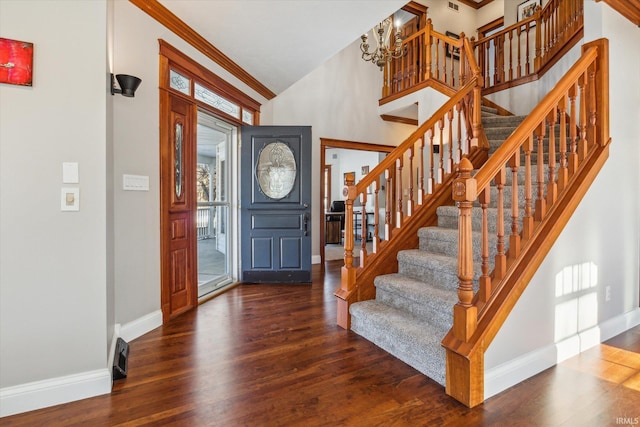 foyer featuring lofted ceiling, crown molding, and dark wood-type flooring